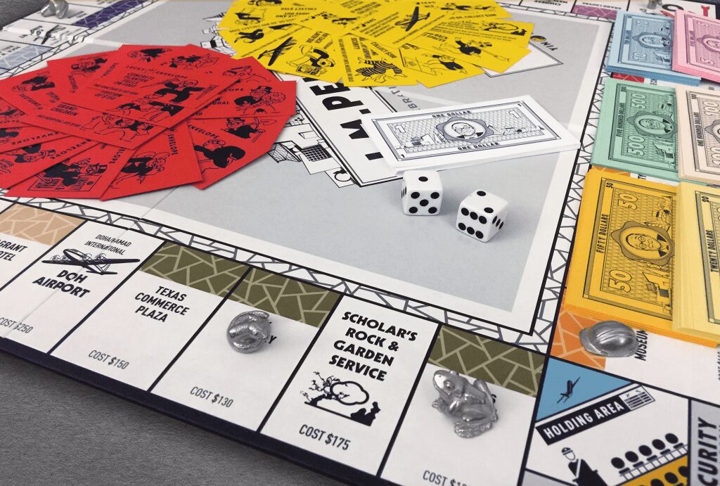 Board game close-up showing dice, cards, money